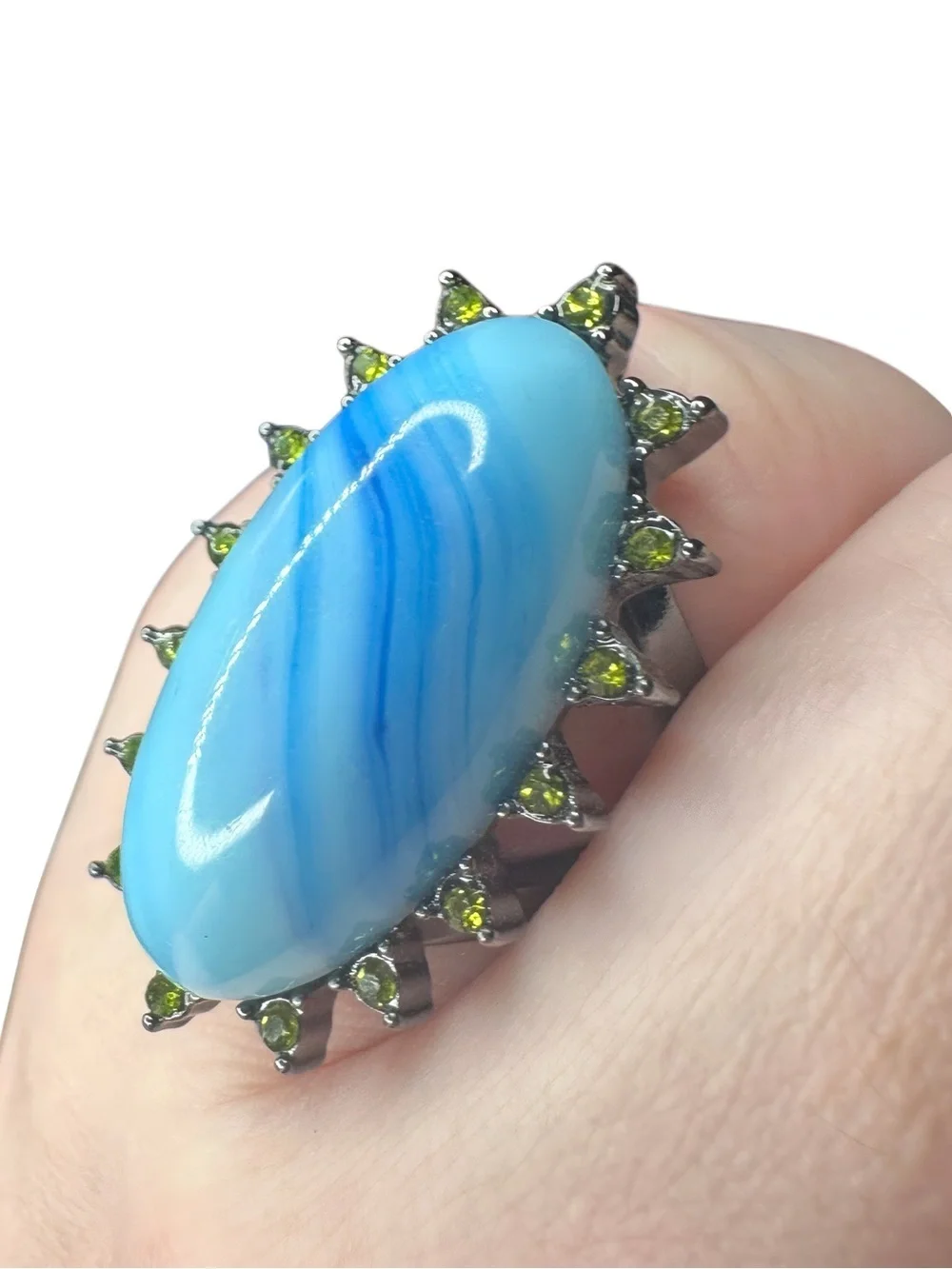 Blue Oval Stone Ring with Green Accent Stones